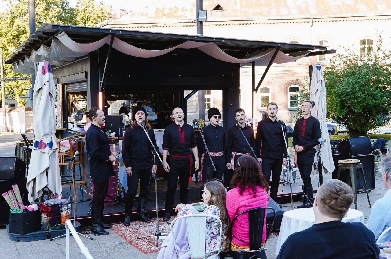 Vocal ensemble in traditional shirts performing outdoors