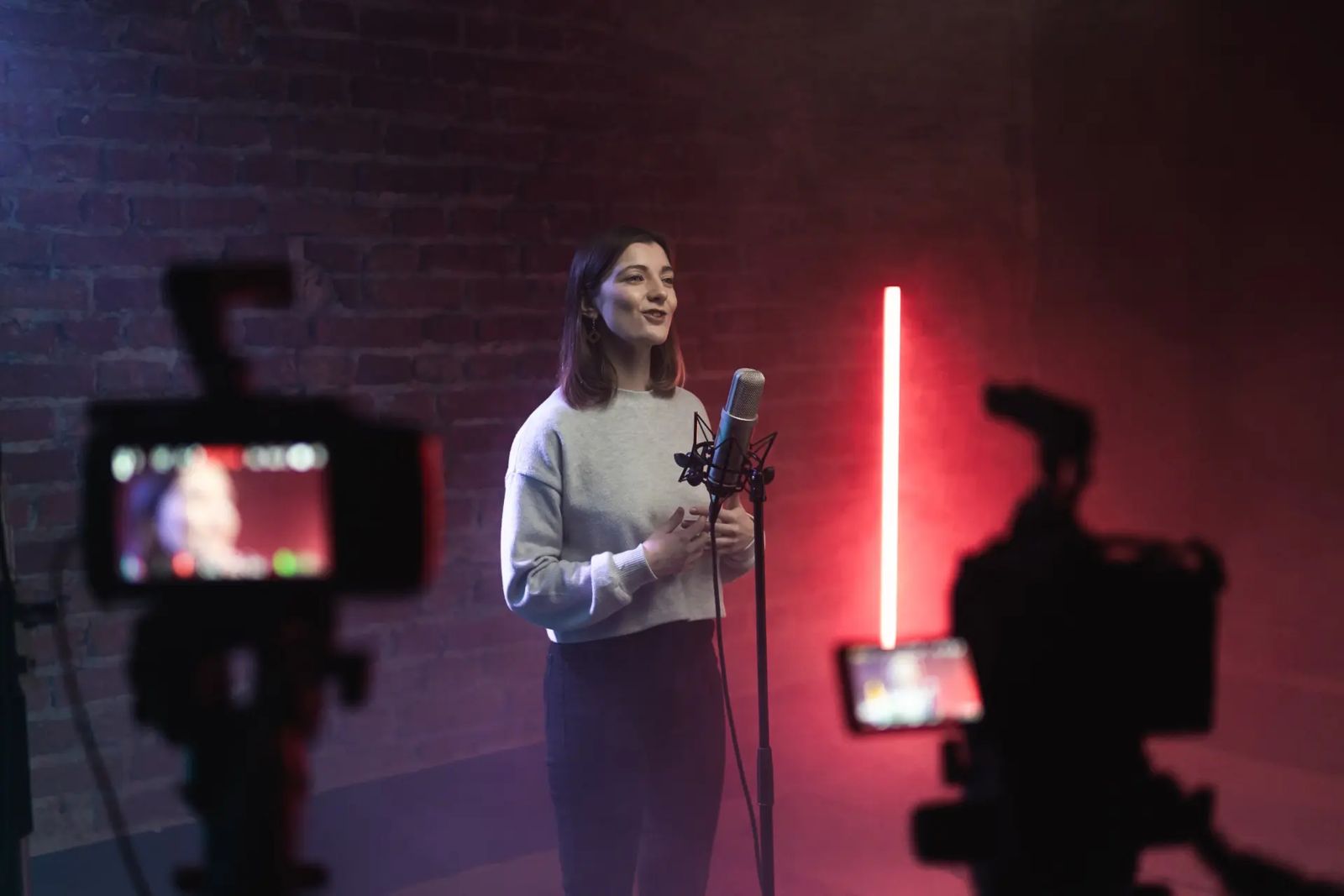 Presenter recording a live video session with cameras and microphone