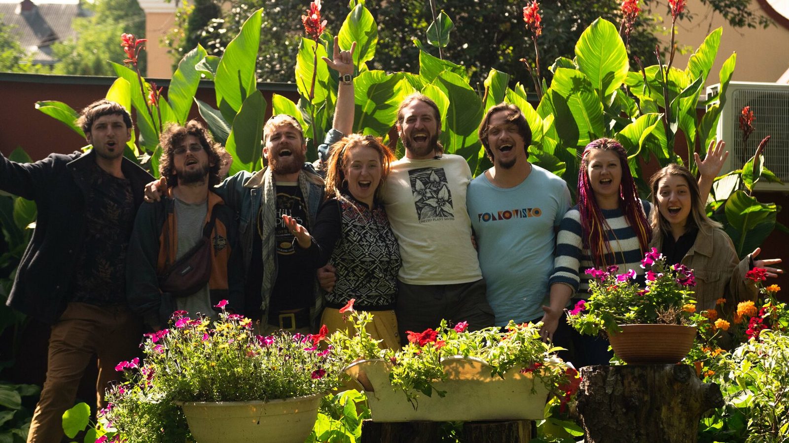 Slavalachia musicians celebrating together in a sunlit garden