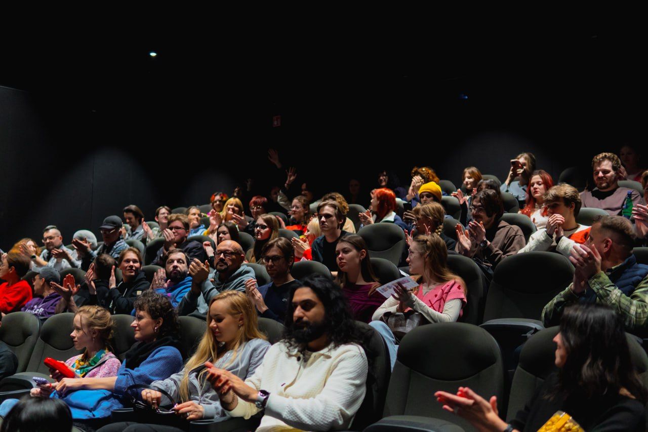 Audience applauding during a film screening in a cinema