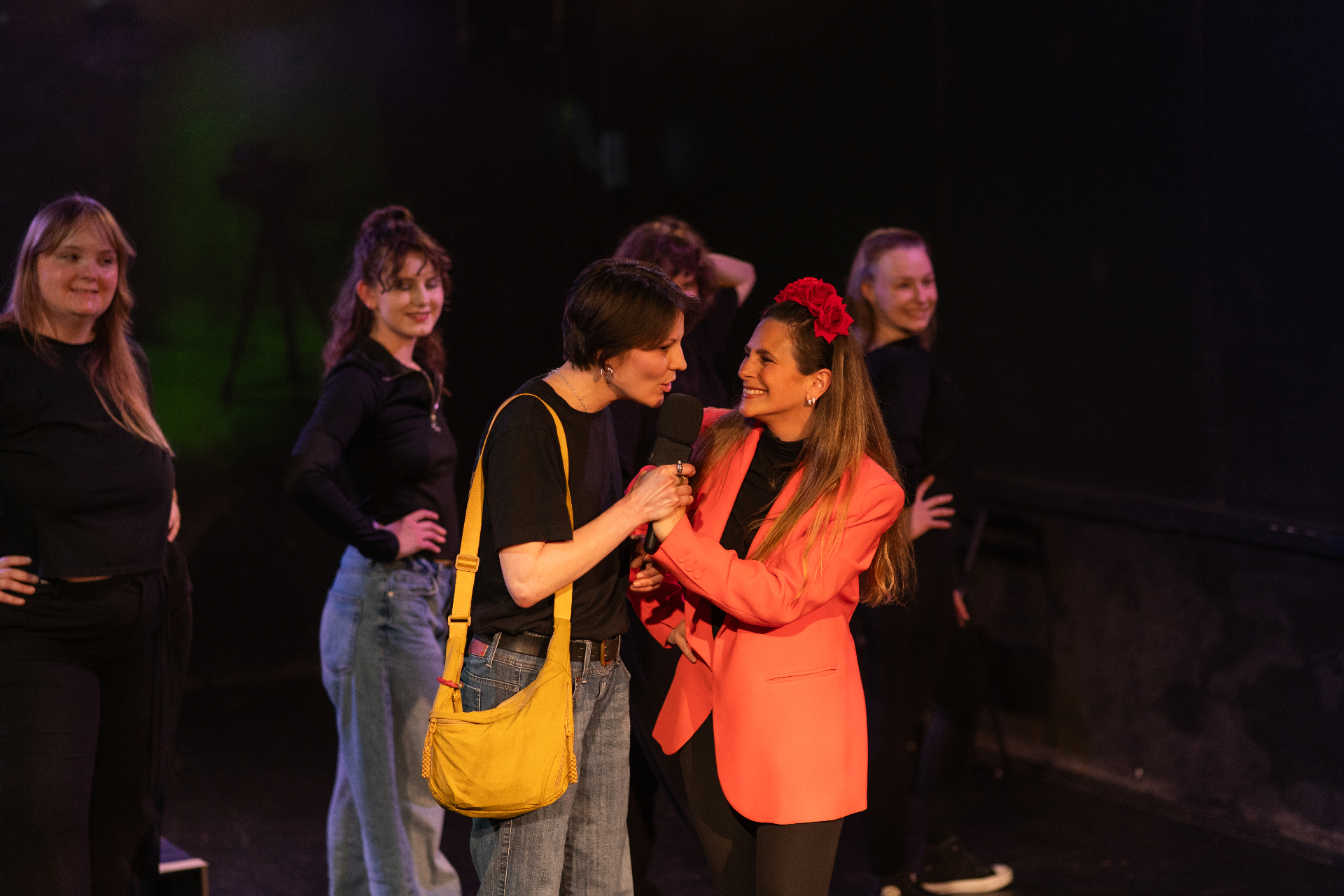 Two performers sharing a microphone at the final performance